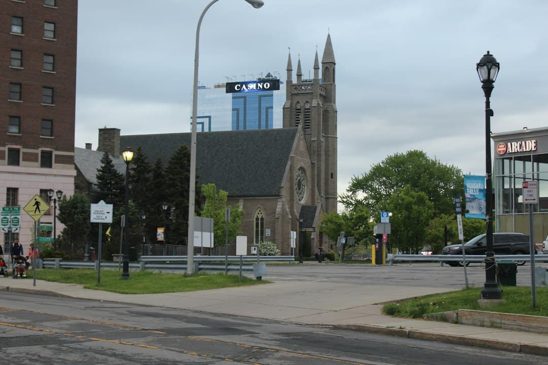 a large church with a tall tower next to a street — Photo by srinivas Kodali on Unsplash