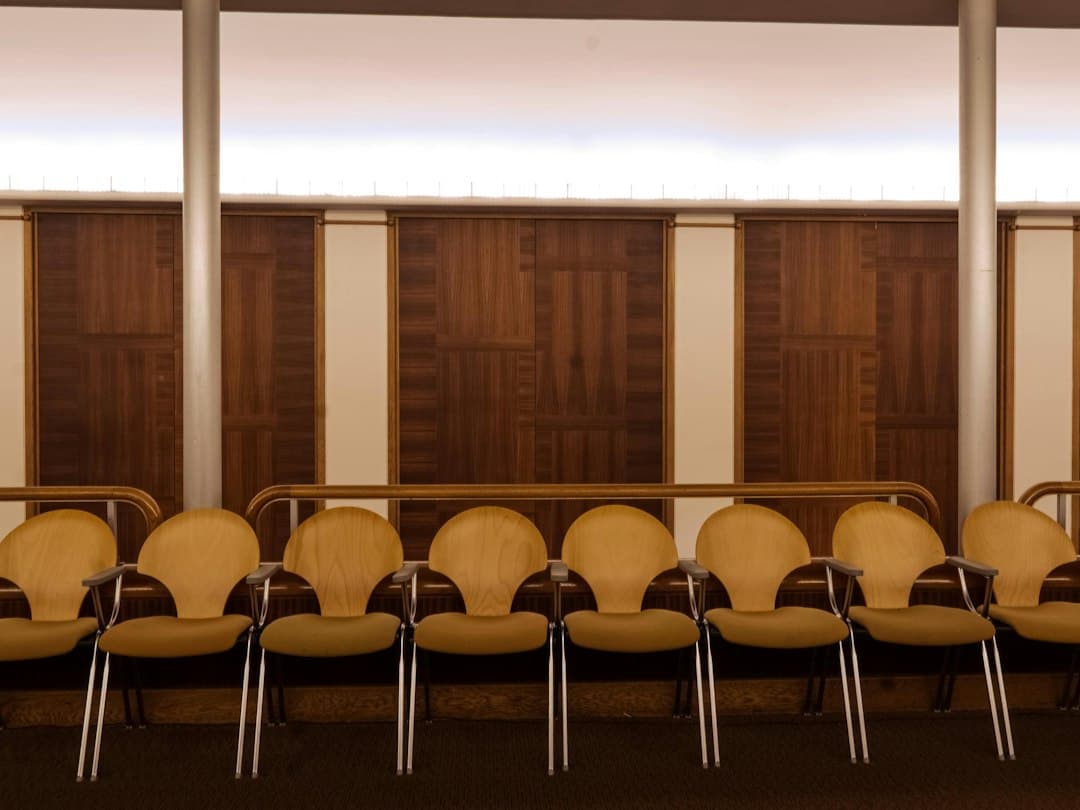 a row of empty chairs in a room — Photo by Alain Pierre-Lys on Unsplash