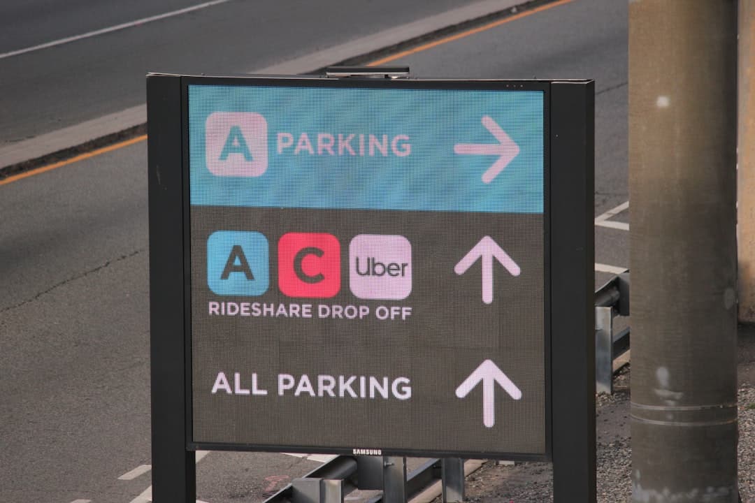 A parking sign on the side of the road — Photo by Frolicsome Fairy on Unsplash