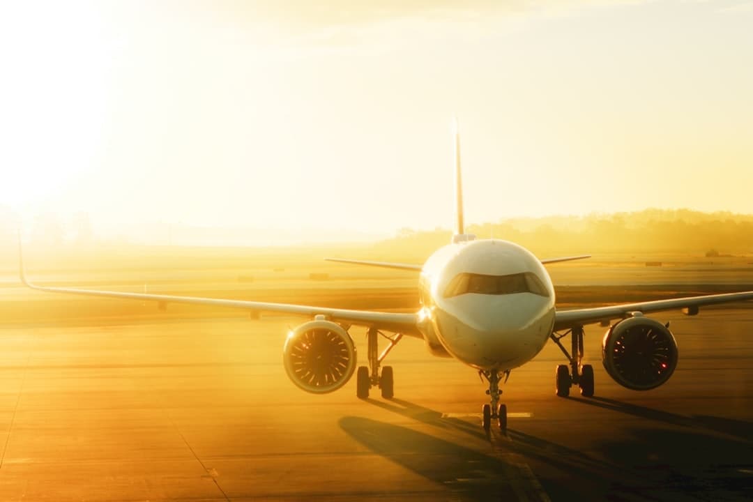 Airplane on tarmac at sunrise — Photo by Daniel Gomez on Unsplash