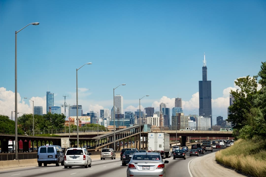 cars on road near city buildings during daytime — Photo by Connor Betts on Unsplash