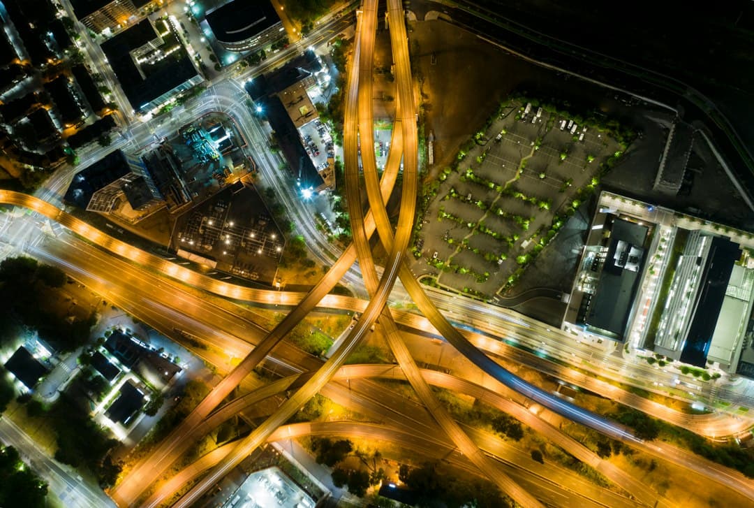 aerial photo of moving vehicles on road at night — Photo by Dan Meyers on Unsplash