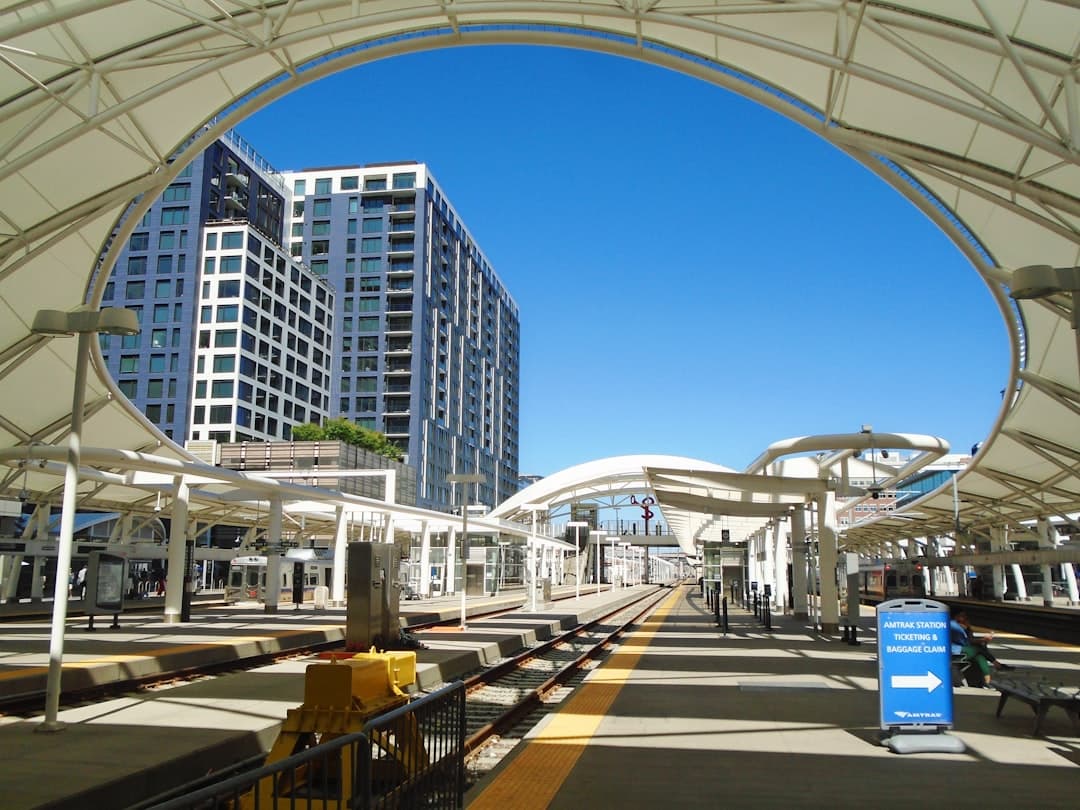 a train station with a train on the tracks — Photo by Huw Edwards on Unsplash