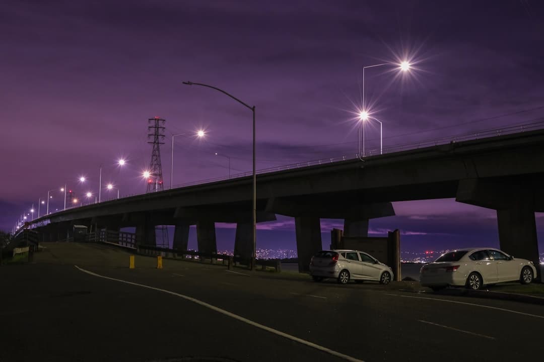 A night scene of a highway with cars driving on it — Photo by David Yao on Unsplash