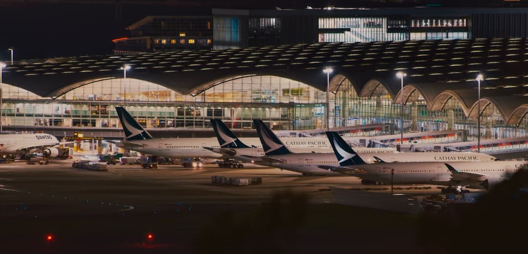 a row of airplanes parked at an airport — Photo by Sugarman Joe on Unsplash