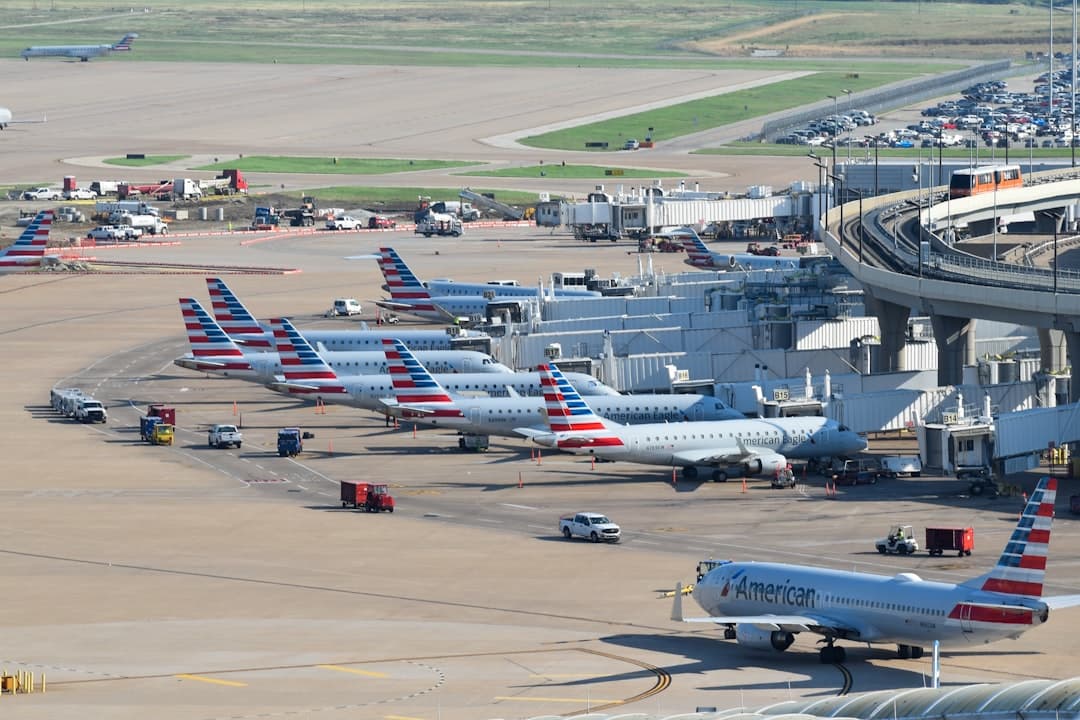 an airport filled with lots of airplanes parked on top of tarmac — Photo by David Syphers on Unsplash