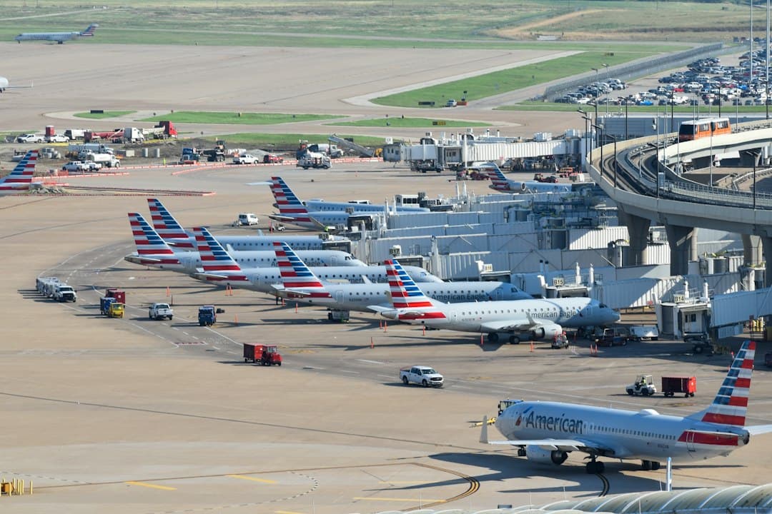 an airport filled with lots of airplanes parked on top of tarmac — Photo by David Syphers on Unsplash