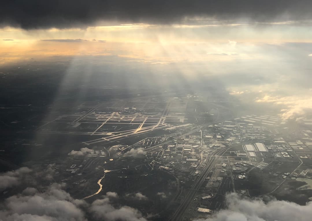 the sun shines through the clouds over a city — Photo by Javier Vinals on Unsplash