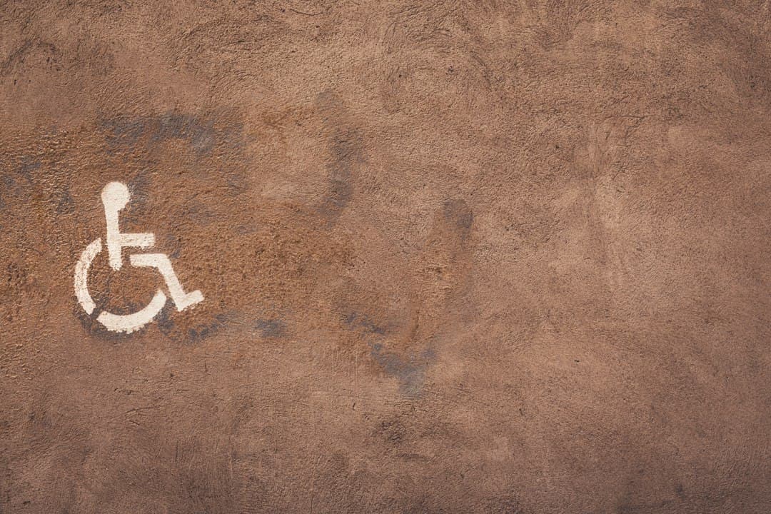a handicap sign painted on the side of a wall — Photo by Tim Mossholder on Unsplash
