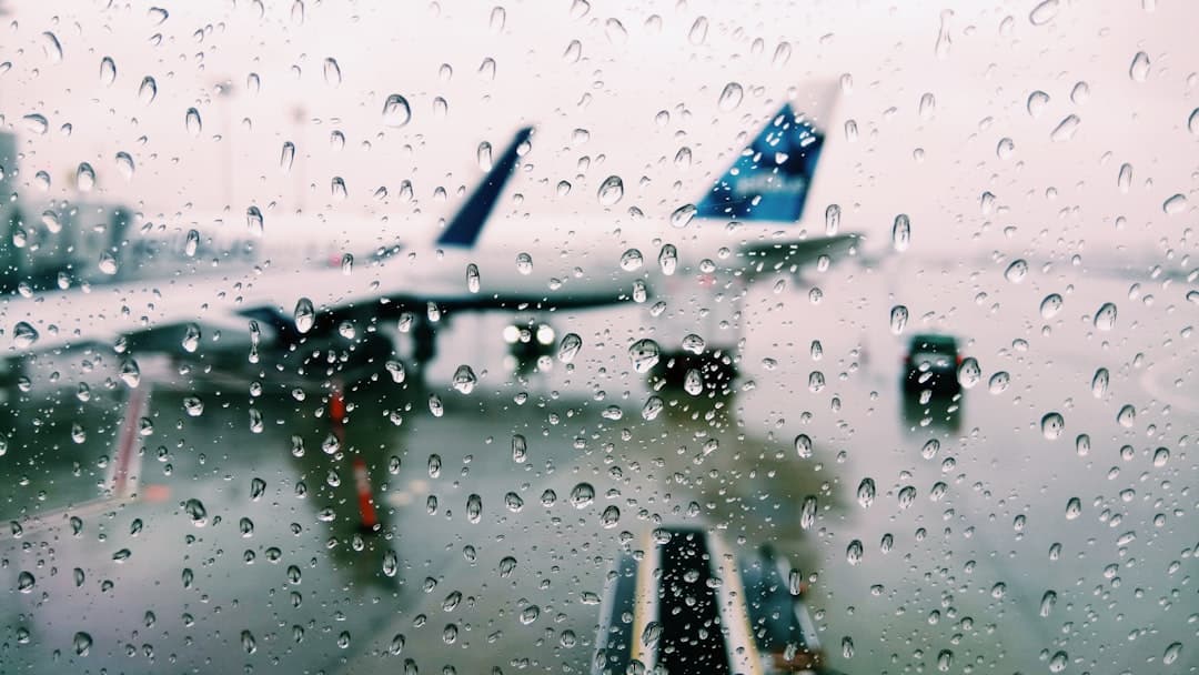 water drops viewing white and blue airplane — Photo by Asael Peña on Unsplash