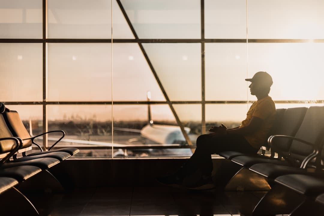 man sitting on gang chair near window — Photo by Marco López on Unsplash