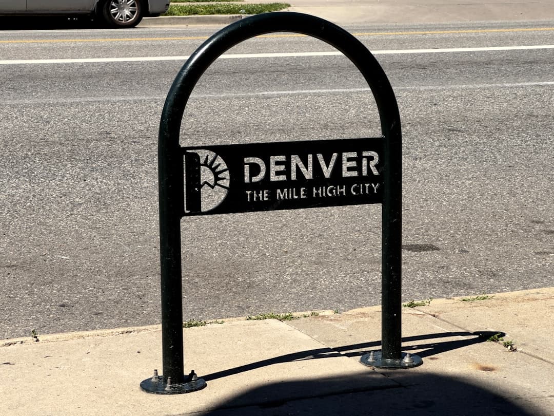 a sign on the side of the road that says denver the mile high city — Photo by Noah Sandoval on Unsplash