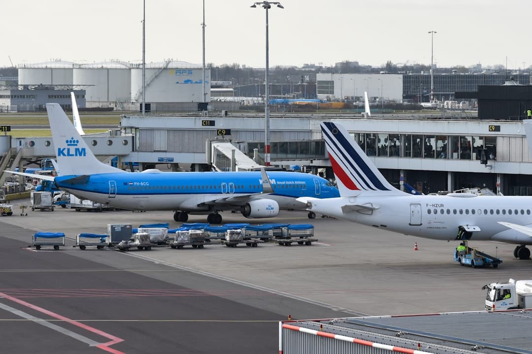 Airplanes are parked at an airport terminal. — Photo by David Syphers on Unsplash