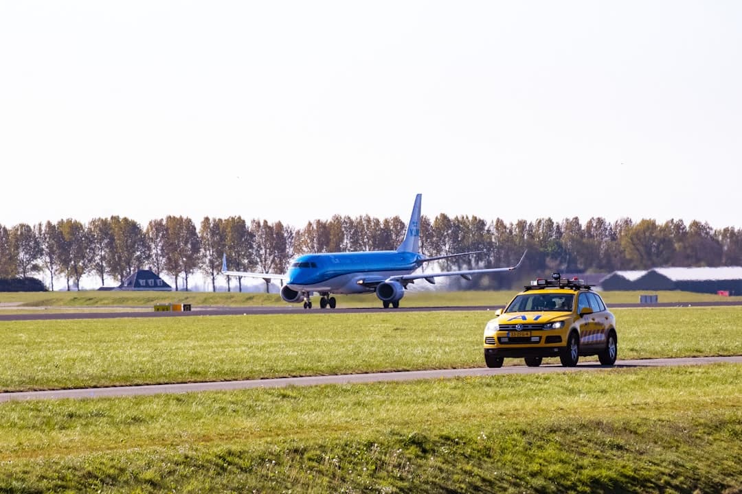 yellow and blue airplane on green grass field during daytime — Photo by Wouter Supardi Salari on Unsplash