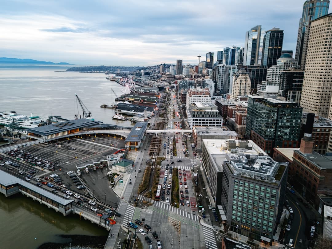 Aerial view of a bustling city waterfront with skyscrapers. — Photo by Josh Hild on Unsplash