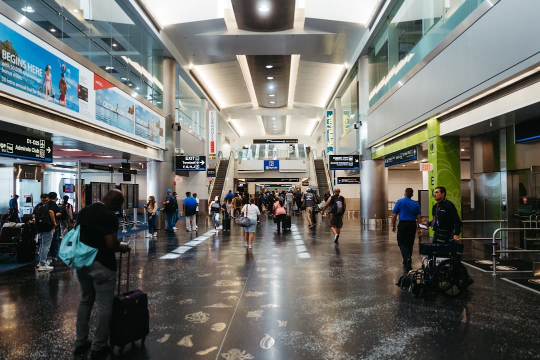 a group of people walking through an airport — Photo by Daniel on Unsplash