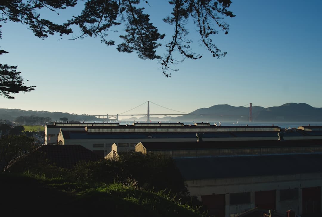 a train traveling over a bridge over a river — Photo by Ozzie Kirkby on Unsplash
