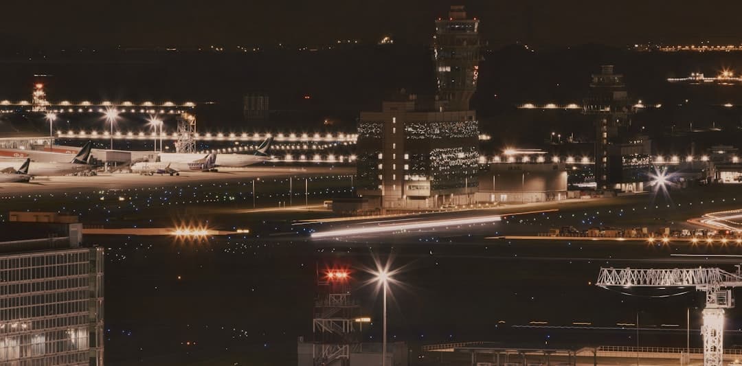 a night time view of an airport with planes parked — Photo by Sugarman Joe on Unsplash