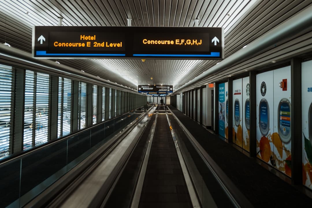 an empty subway station with a sign above it — Photo by Daniel on Unsplash