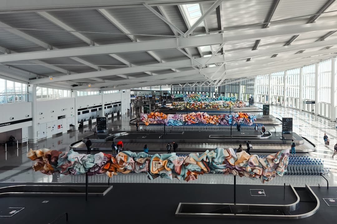A baggage claim area at an airport with a conveyor belt — Photo by Zoshua Colah on Unsplash