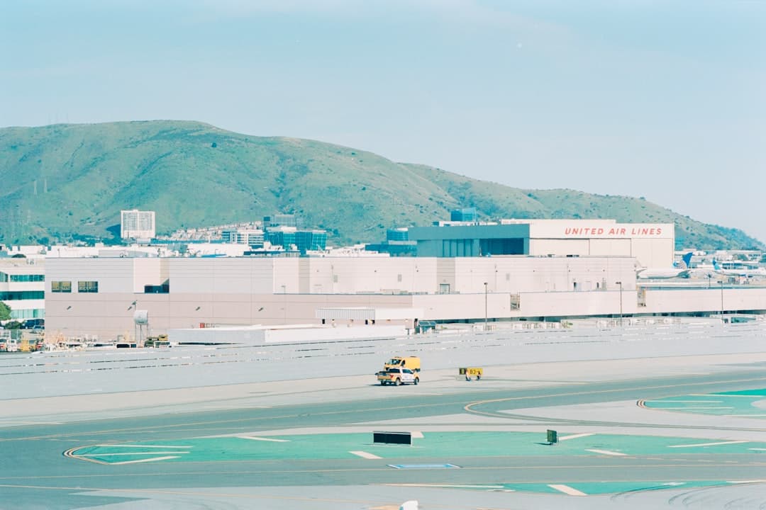 Airport with buildings and a mountain backdrop. — Photo by realfish on Unsplash