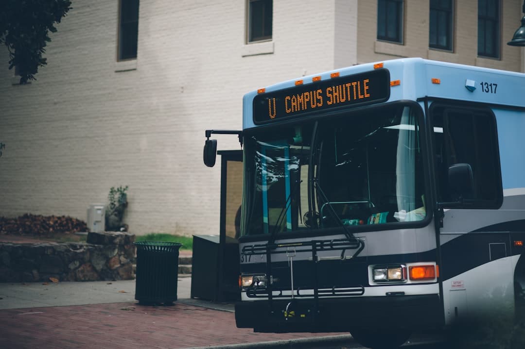 a city bus parked on the side of the road — Photo by Colin Rowley on Unsplash