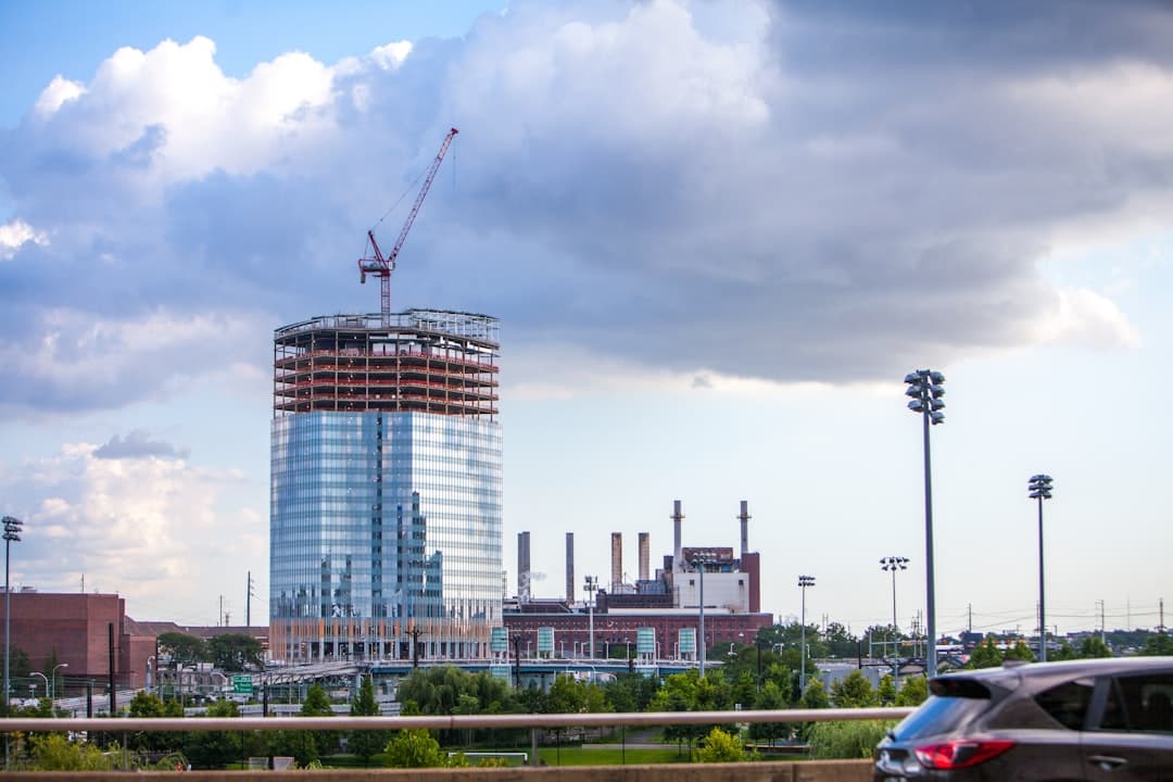white and blue building near green grass field during daytime — Photo by James Lewis on Unsplash