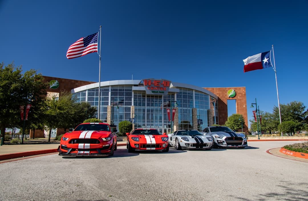 red and black coupe parked beside american flag during daytime — Photo by Wes Tindel on Unsplash