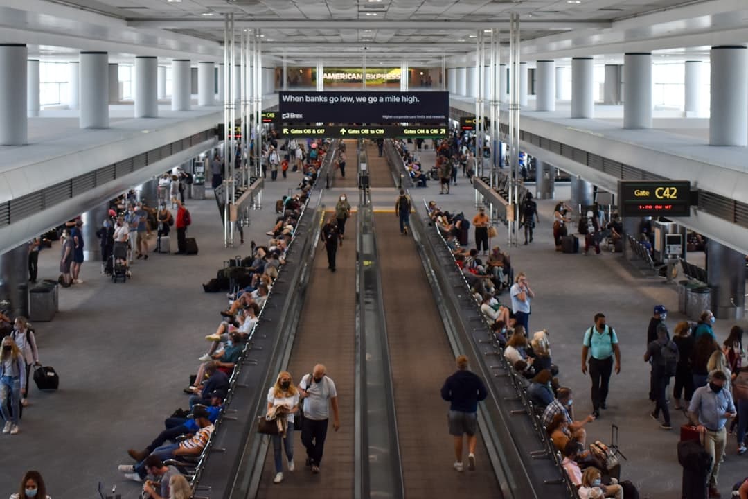 A group of people walking through an airport — Photo by David Syphers on Unsplash