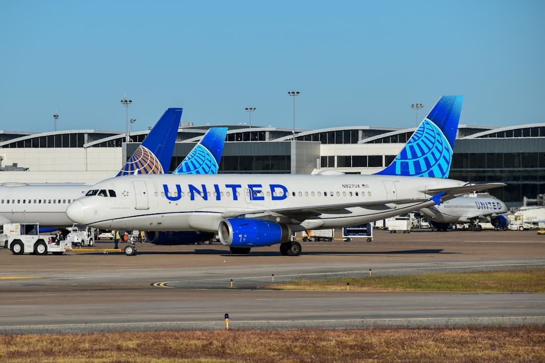 A row of united airlines planes parked at an airport — Photo by David Syphers on Unsplash