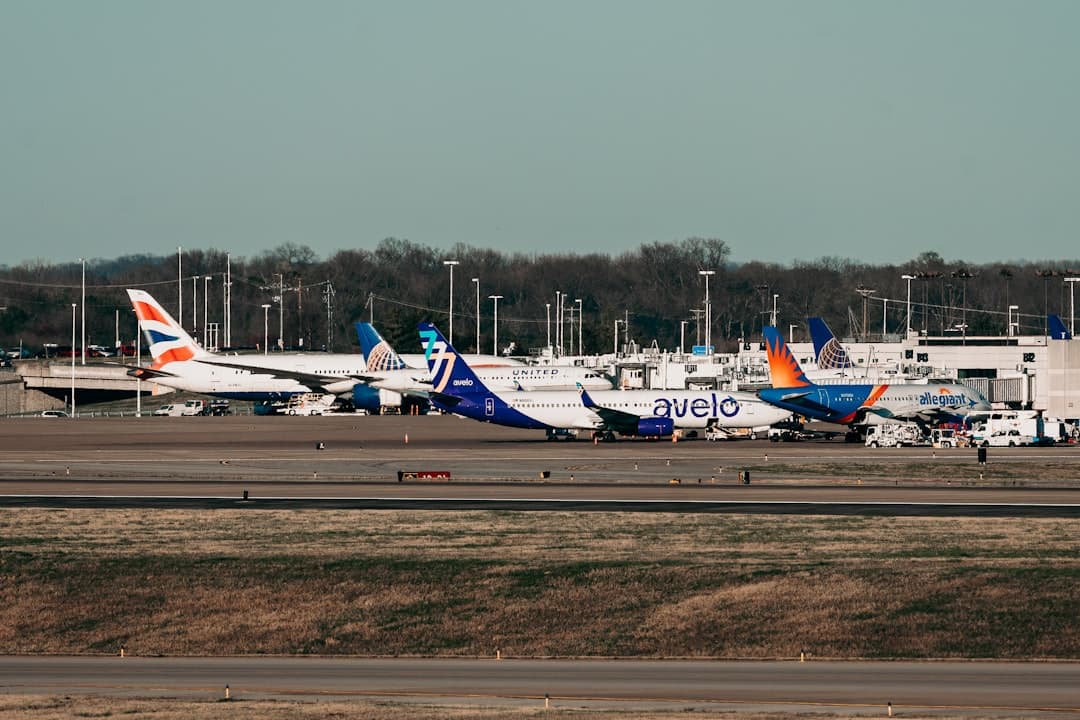 several airplanes are parked on the runway at an airport — Photo by Matthew Jungling on Unsplash
