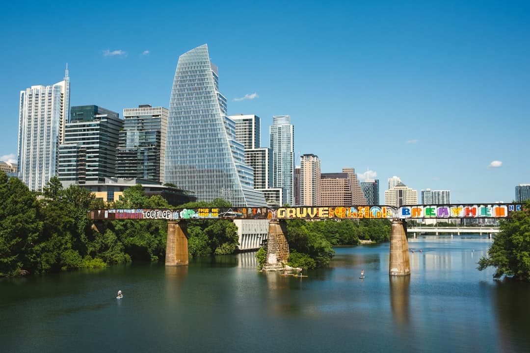 a city skyline with a bridge over a river — Photo by Mack Ramirez on Unsplash