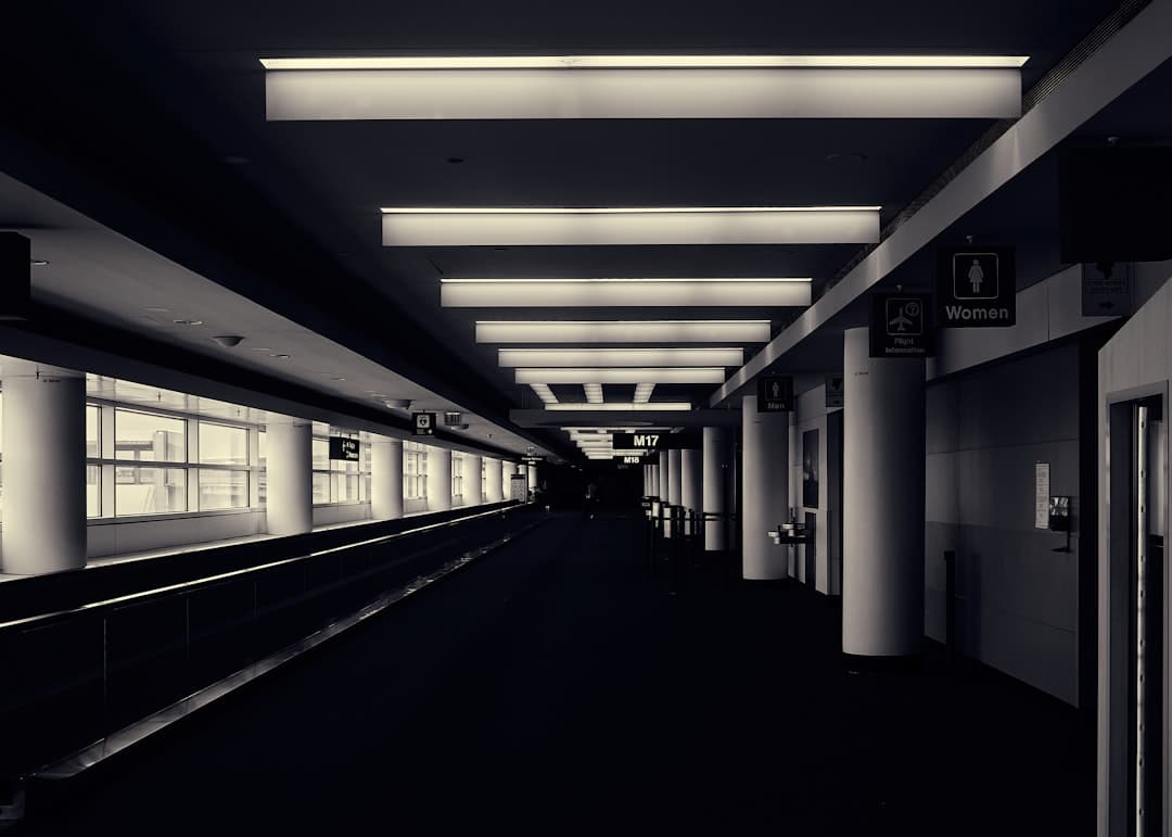 a black and white photo of a train station — Photo by John Unwin on Unsplash