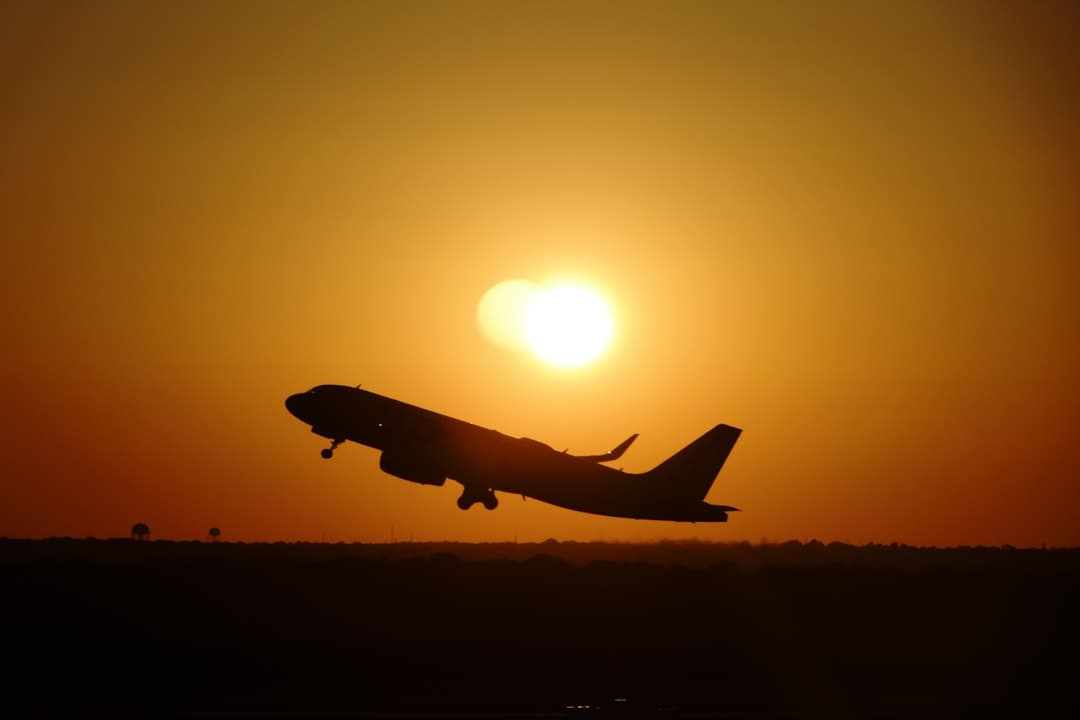 a plane flying in the air at sunset — Photo by Sean Davis on Unsplash