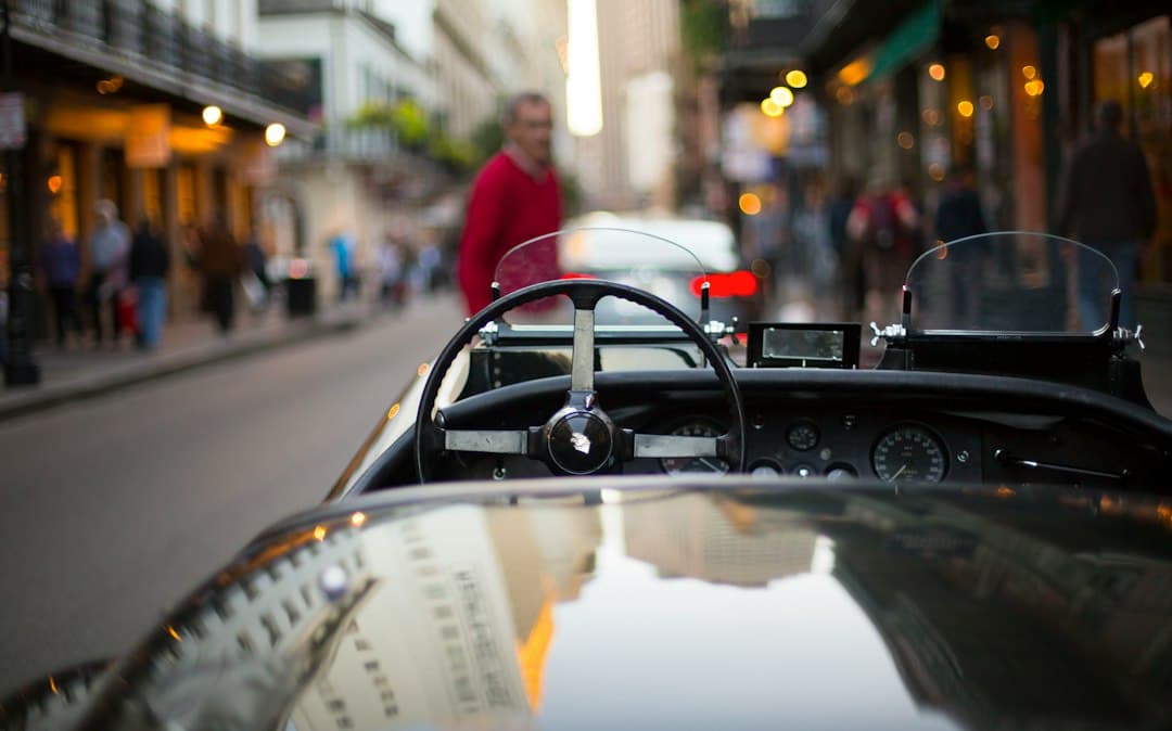 black convertible in front of standing man during daytime — Photo by Evershot on Unsplash