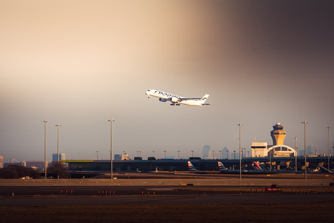 Airplane taking off from airport with control tower — Photo by Hieu on Unsplash