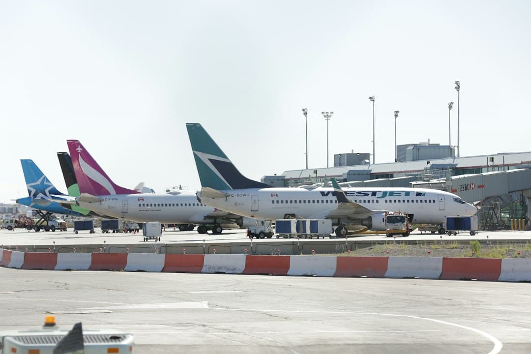 a couple of airplanes that are on a runway — Photo by Michael on Unsplash