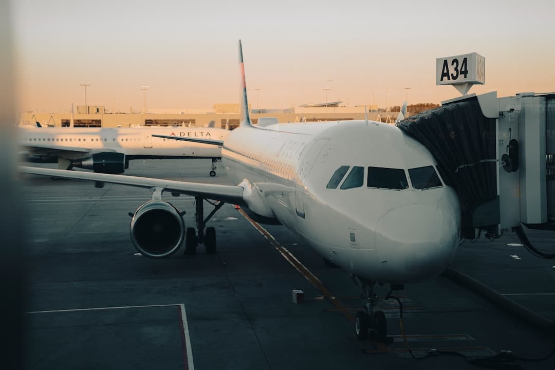 Airplane connected to a jet bridge at sunset. — Photo by Annie V on Unsplash
