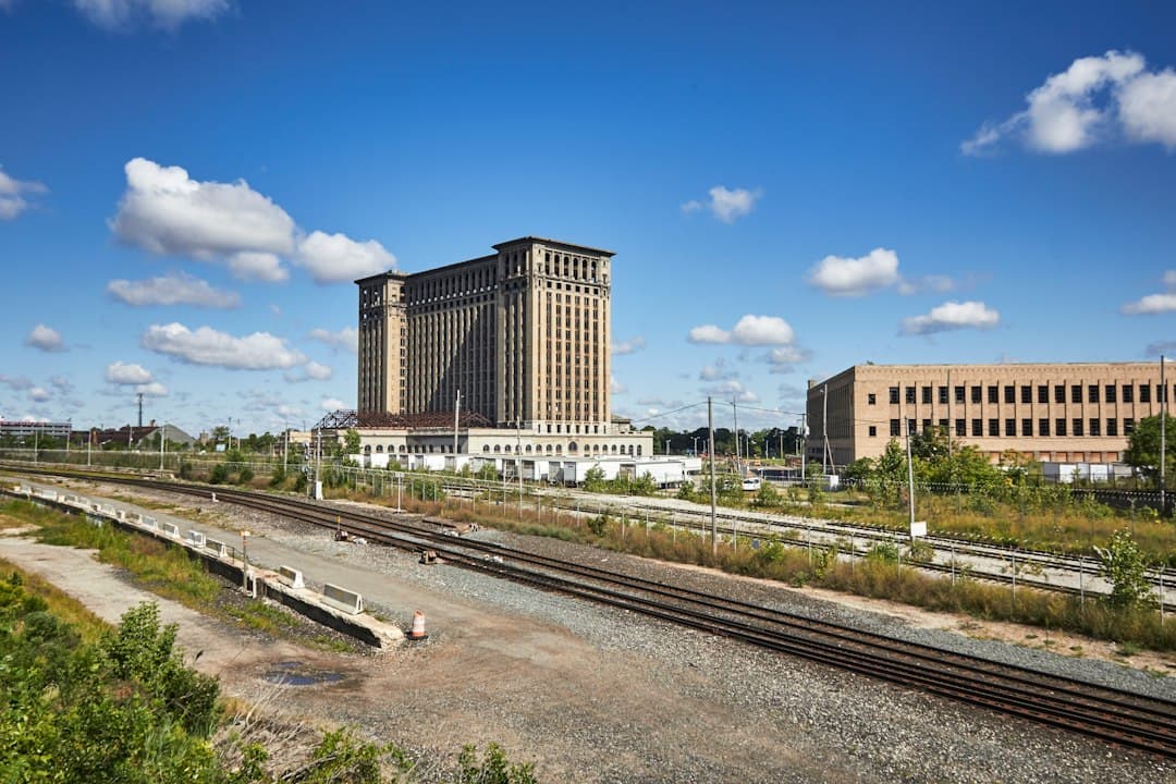 A train track with a building in the background — Photo by Ulrich Kaiser on Unsplash