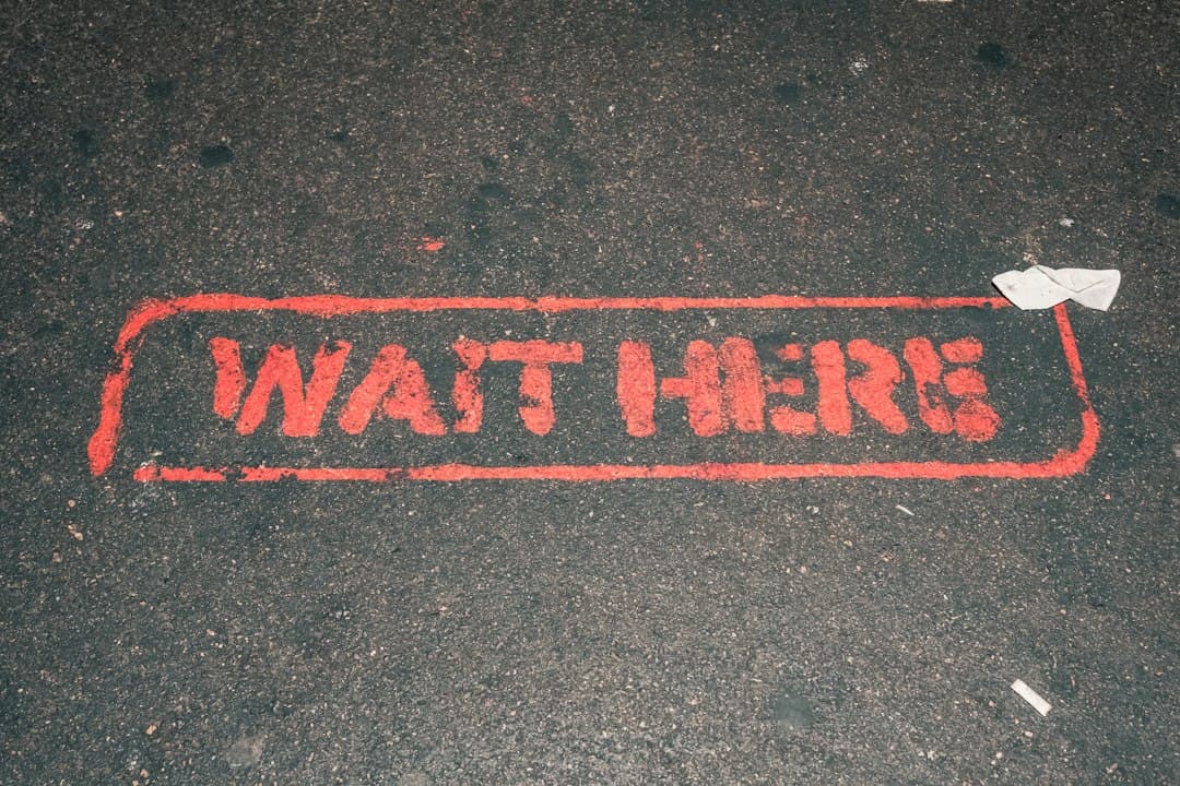 a red street sign that reads wait here — Photo by Gerhard Reus on Unsplash
