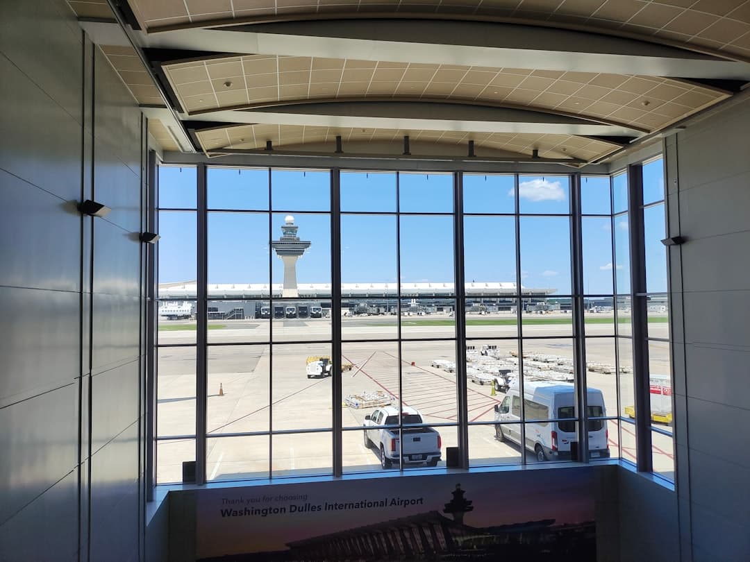a view of an airport through a window — Photo by Joshi Milestoner on Unsplash