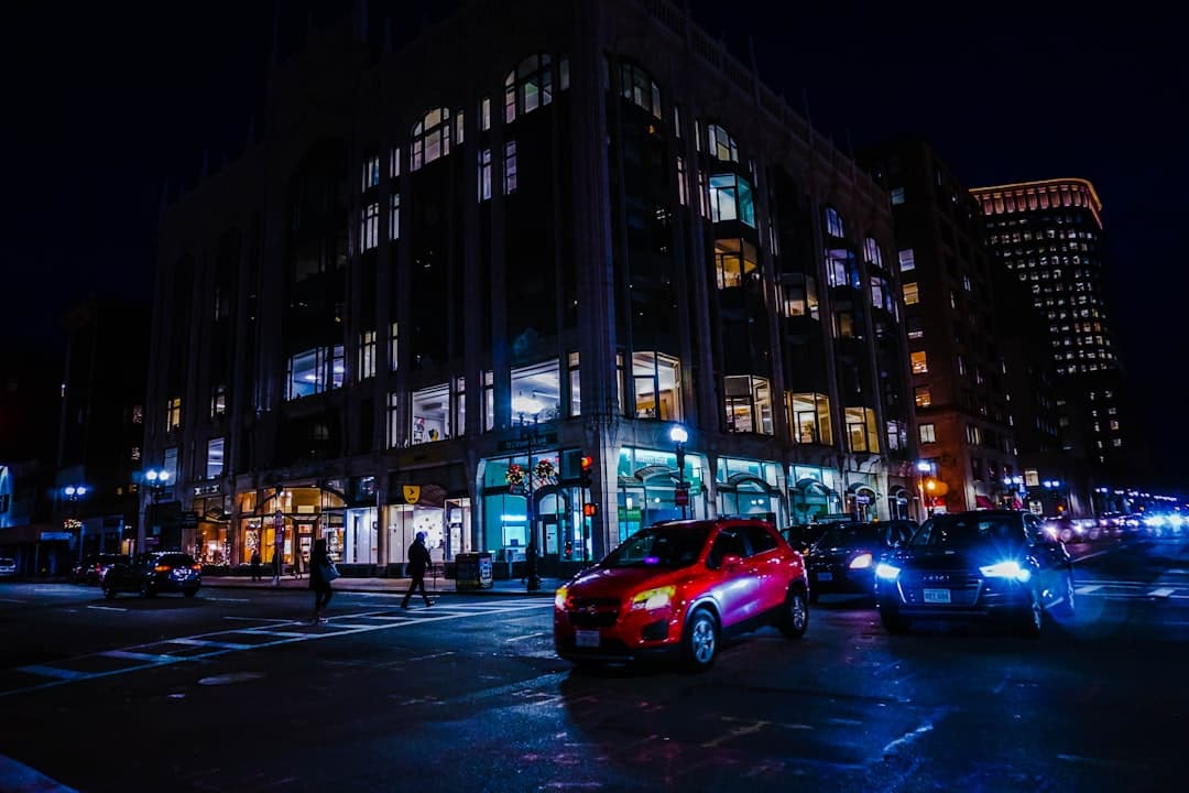 red sedan on road near building during night time — Photo by Kah Hay Chee on Unsplash