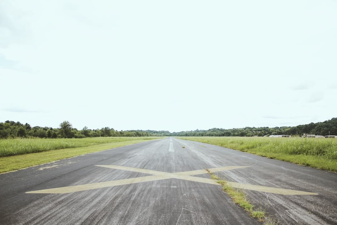gray road surrounded by green grass during daytime — Photo by Matt Bowden on Unsplash