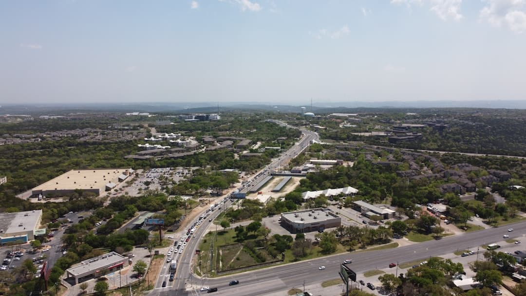 an aerial view of a city with lots of traffic — Photo by Cole G on Unsplash