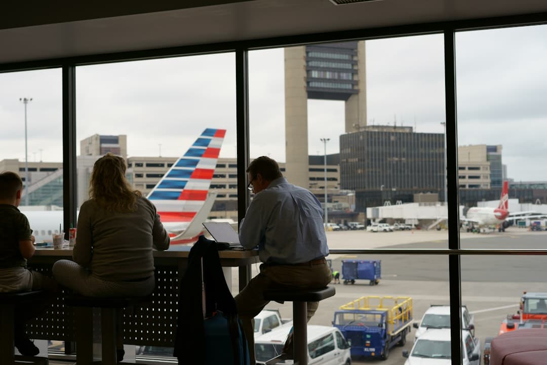 man and woman sitting on chair inside airport — Photo by Talal Ahmad on Unsplash