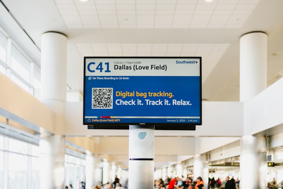 Airport sign showing flight information and bag tracking — Photo by Fujiphilm on Unsplash