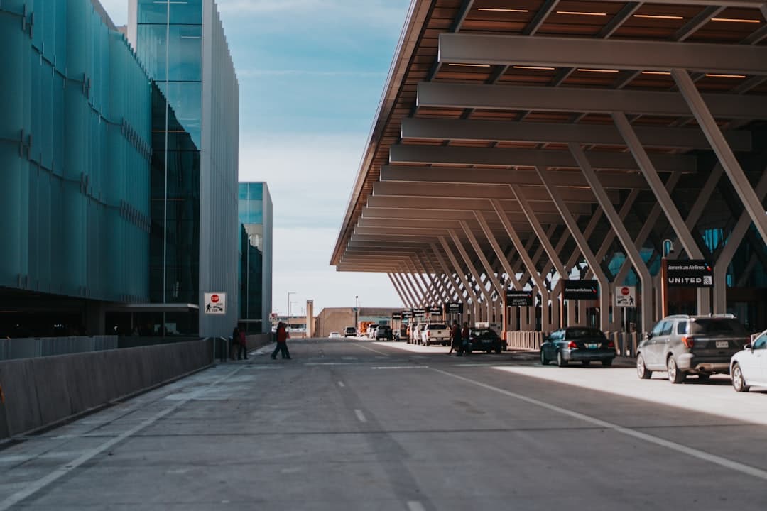 a street with cars parked in front of a building — Photo by Andrew Akabane on Unsplash