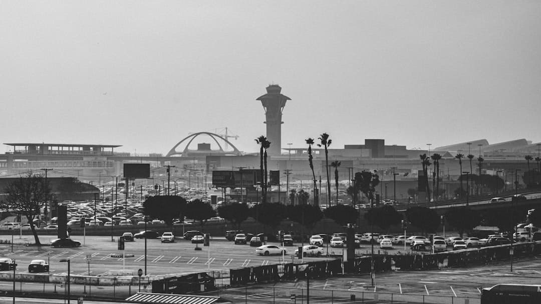 Airport control tower and terminals with busy parking lot — Photo by Hieu on Unsplash