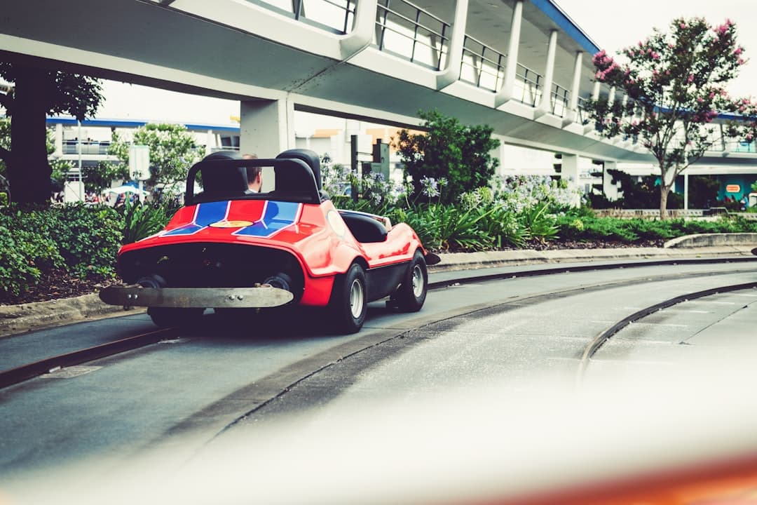 a red and blue toy car driving down a track — Photo by Tim Mossholder on Unsplash