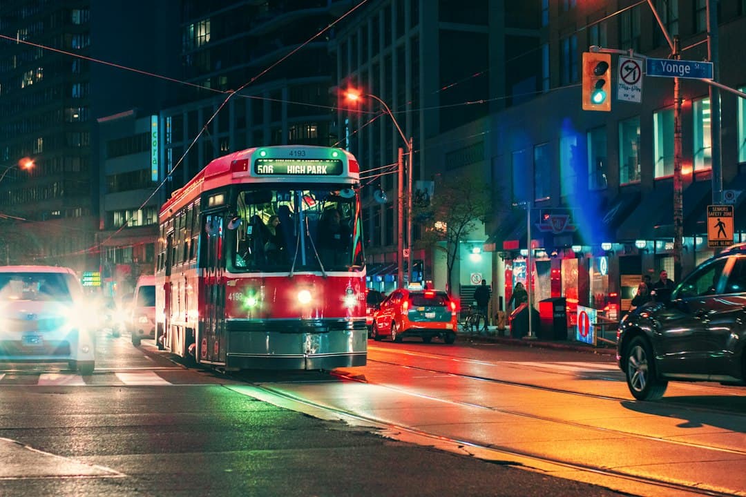 red and white tram on road during nighttime — Photo by Tiago Louvize on Unsplash